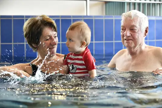 Grandparents et bébé profitent du lagune d'eau chaude